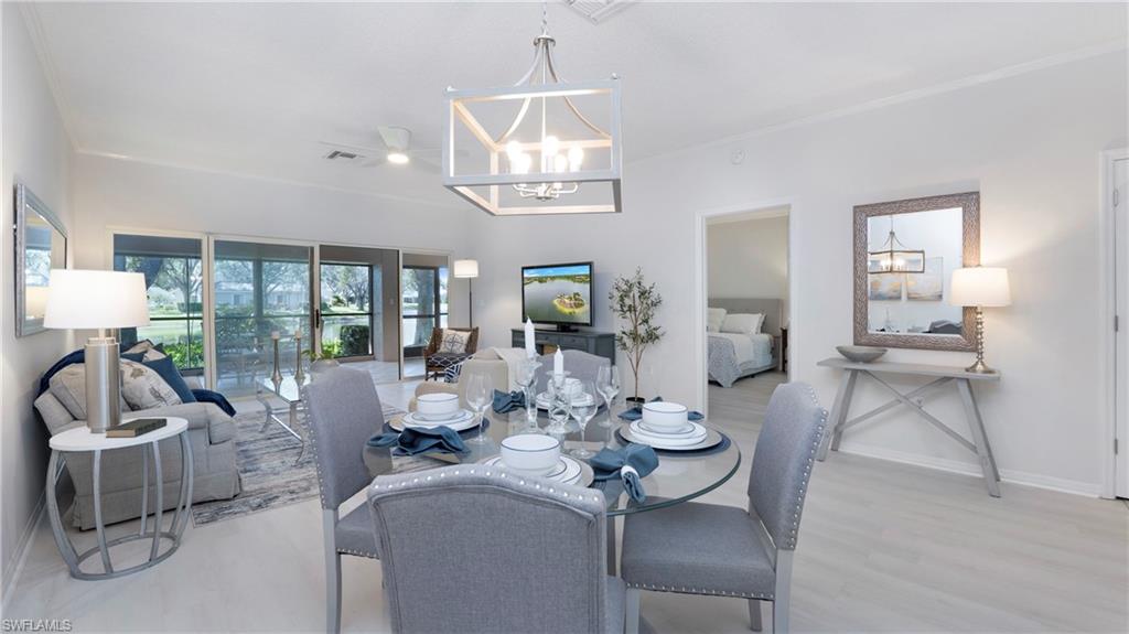 606 Arbor Lake Drive, Unit 6104 Naples, FL 34110 - Photo 10 of 36 a living room with furniture a chandelier and a dining table