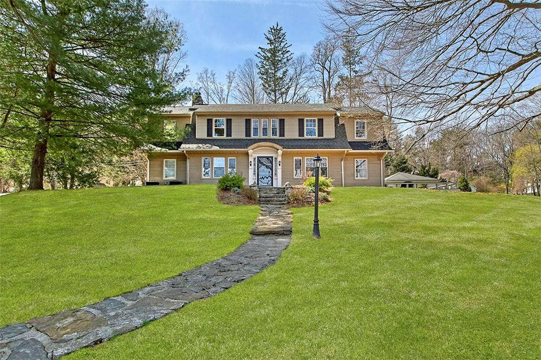 a front view of a house with a yard table and chairs