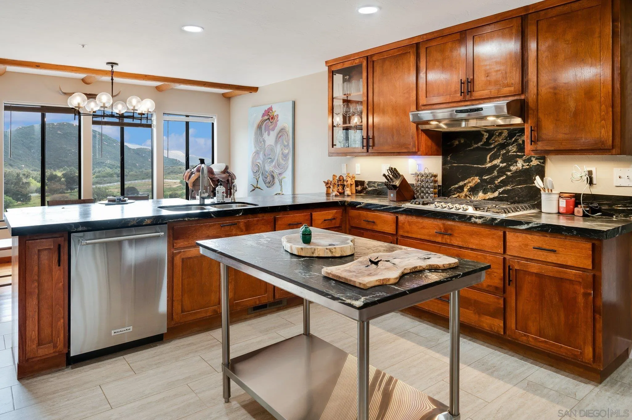 17287 Oak Hollow Road Ramona, CA 92065 - Photo 13 of 71 a kitchen with stainless steel appliances granite countertop table chairs sink and cabinets