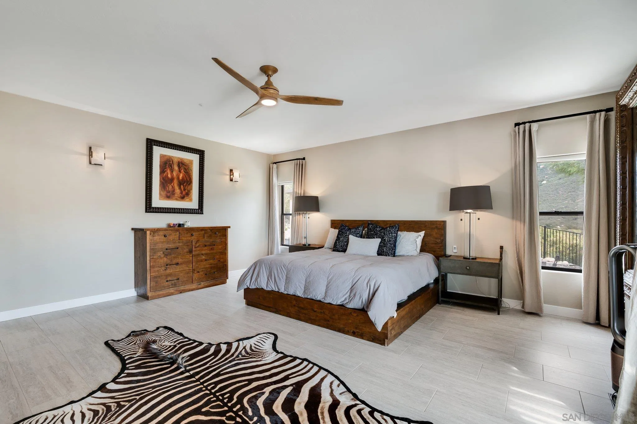 17287 Oak Hollow Road Ramona, CA 92065 - Photo 21 of 71 a bedroom with a bed and a chandelier