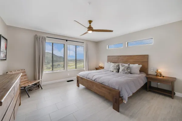 a bedroom with a large bed and a large window
