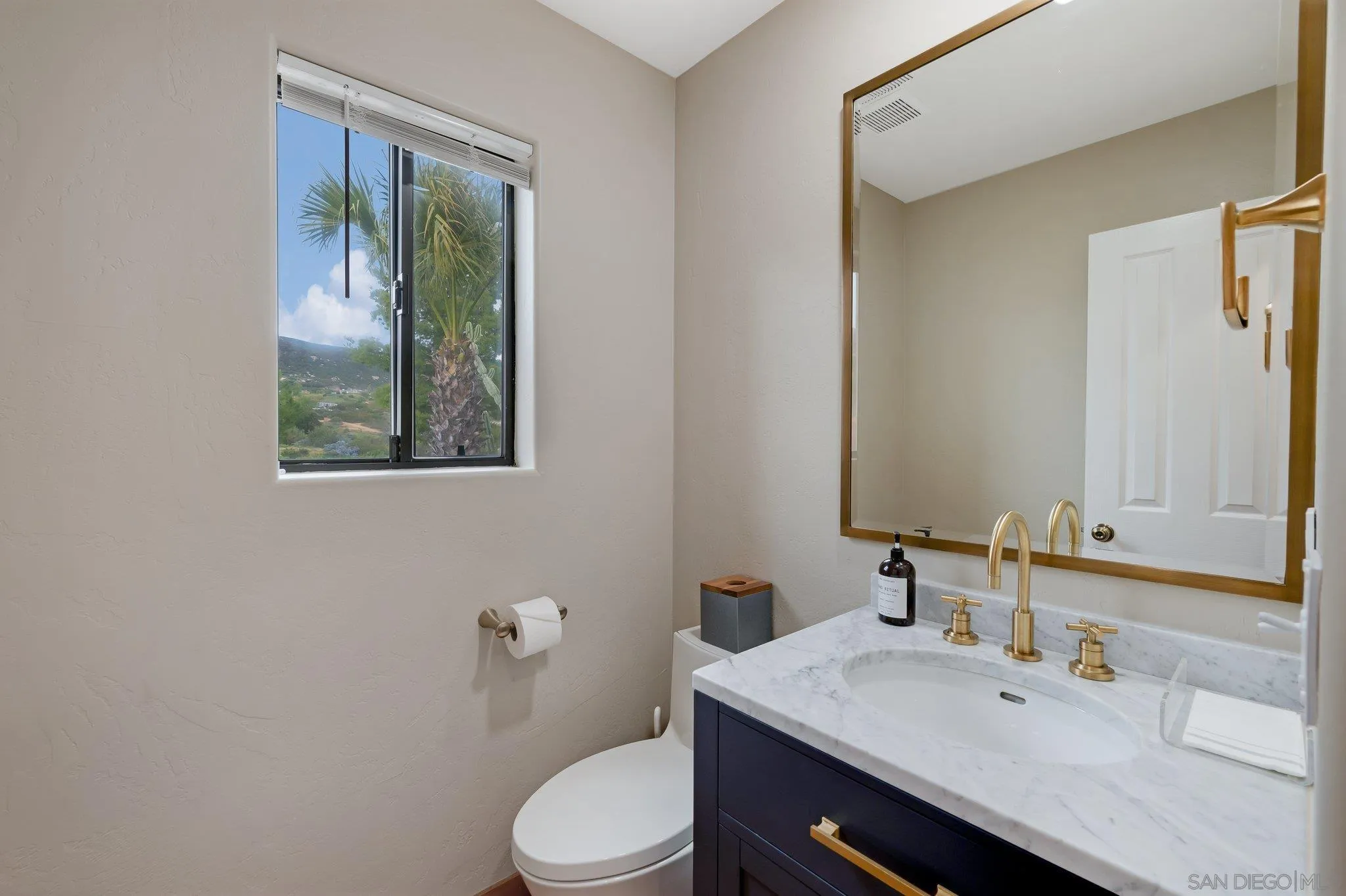17287 Oak Hollow Road Ramona, CA 92065 - Photo 32 of 71 a bathroom with a granite countertop sink mirror vanity and toilet