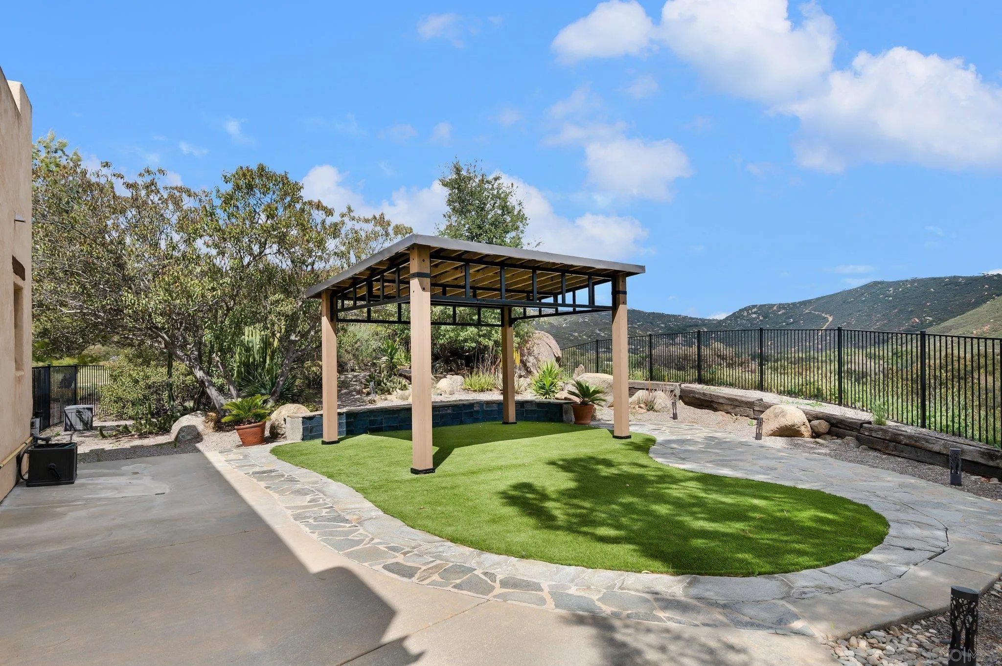 17287 Oak Hollow Road Ramona, CA 92065 - Photo 44 of 71 a view of a house with backyard sitting area and garden