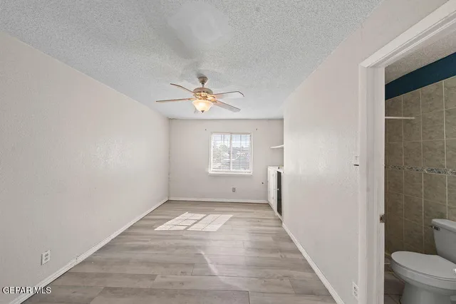 a view of an empty room with a bathroom