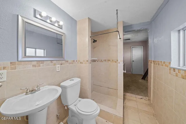 a bathroom with a toilet sink and shower