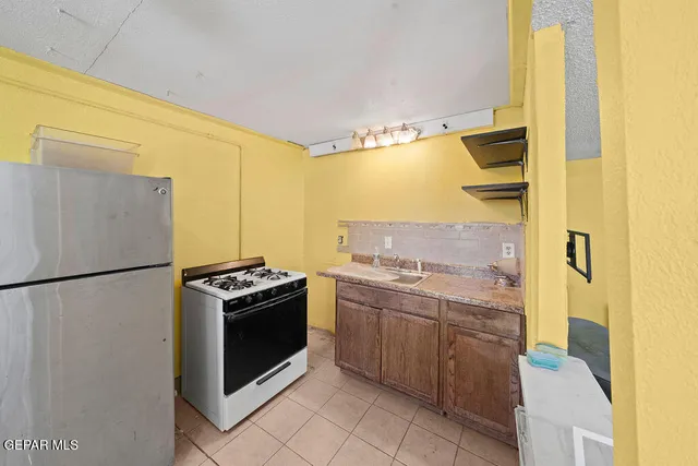 a kitchen with a stove and a refrigerator
