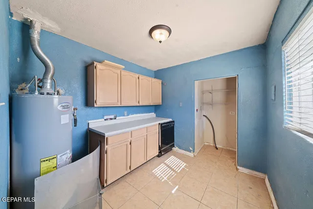 a kitchen with a stove a refrigerator and a sink
