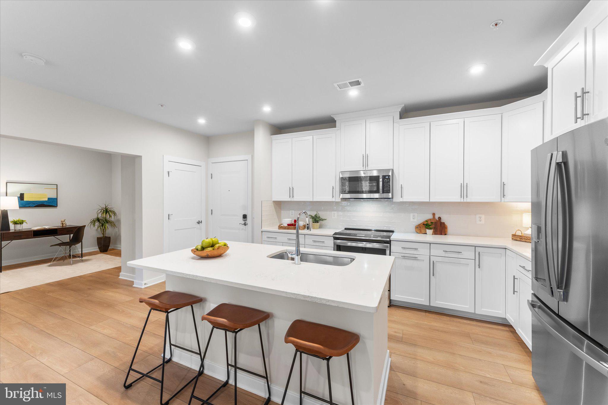 1669 Bandit Loop, Unit 206A Reston, VA 20190 - Photo 2 of 60 a kitchen with stainless steel appliances a stove a sink a refrigerator and chairs