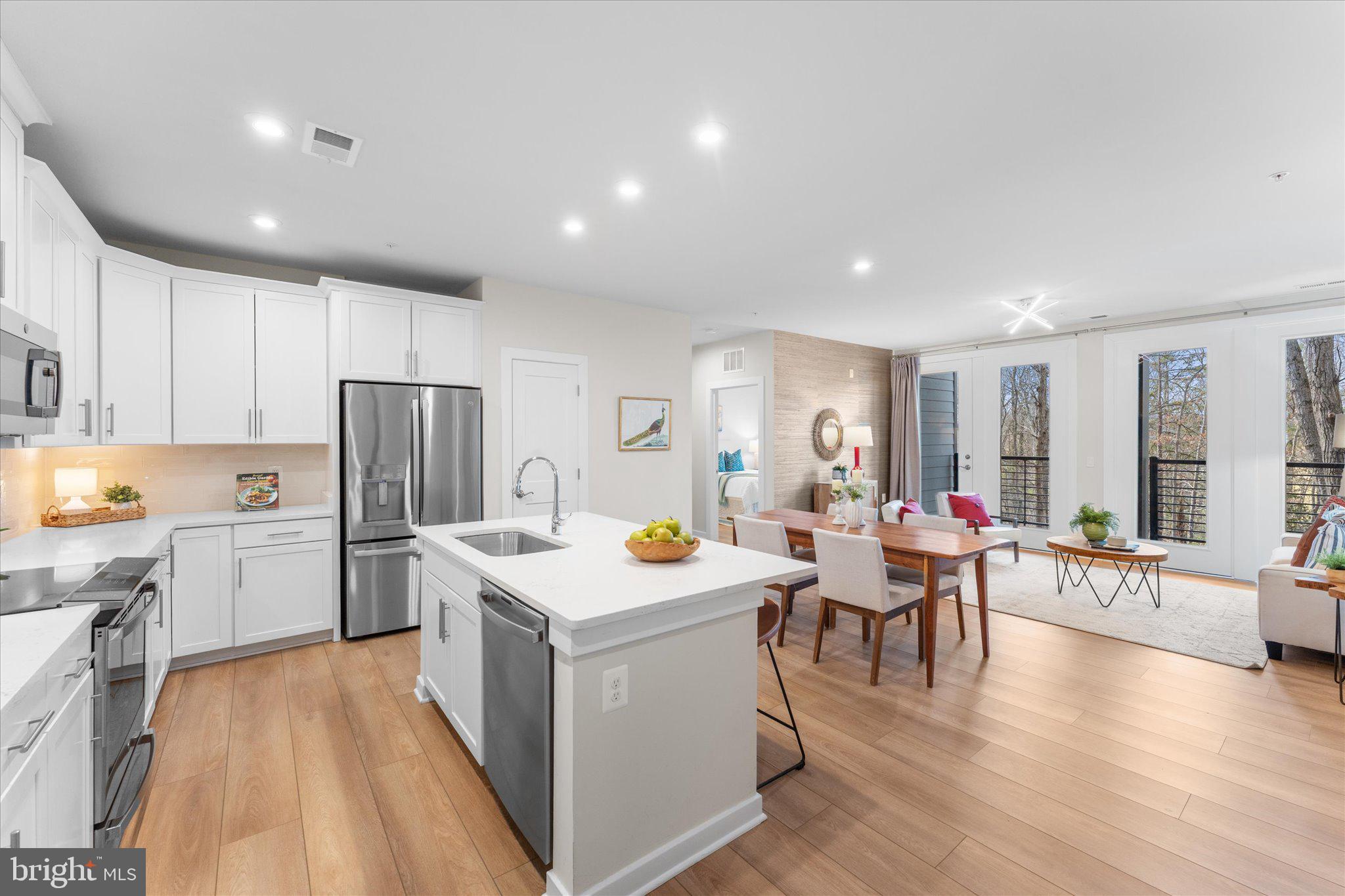 1669 Bandit Loop, Unit 206A Reston, VA 20190 - Photo 3 of 60 a kitchen that has a lot of cabinets a sink and appliances in it