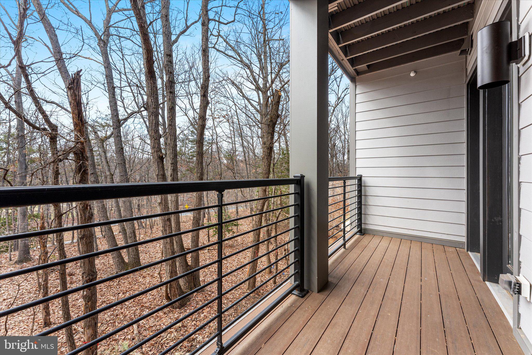 1669 Bandit Loop, Unit 206A Reston, VA 20190 - Photo 32 of 60 a view of a balcony with wooden floor and fence