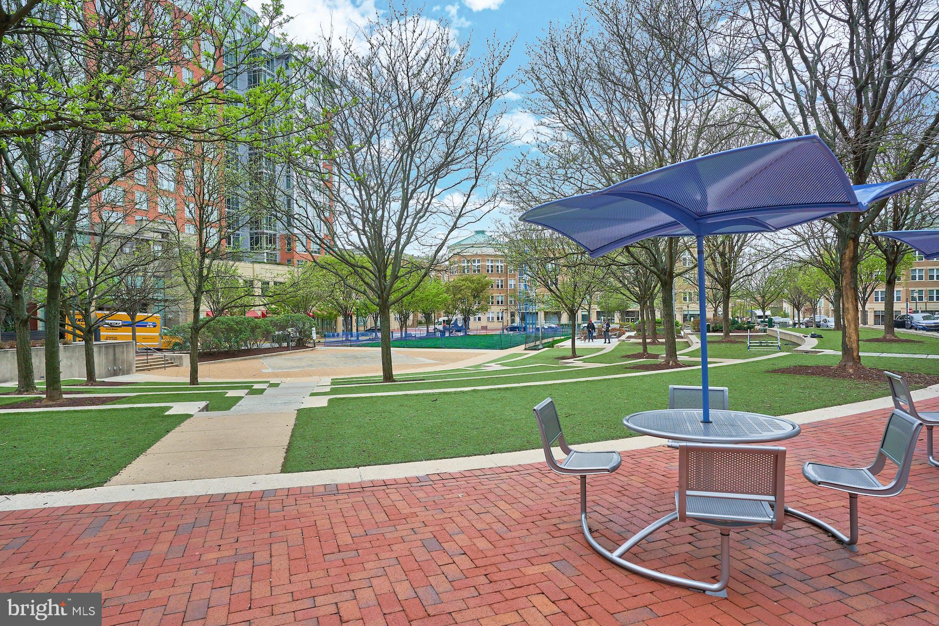 1669 Bandit Loop, Unit 206A Reston, VA 20190 - Photo 43 of 60 a view of a table and chairs in the garden