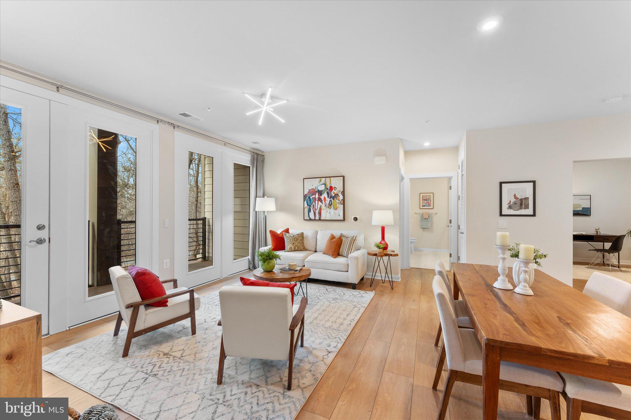 1669 Bandit Loop, Unit 206A Reston, VA 20190 - Photo 5 of 60 a living room with furniture and a wooden floor