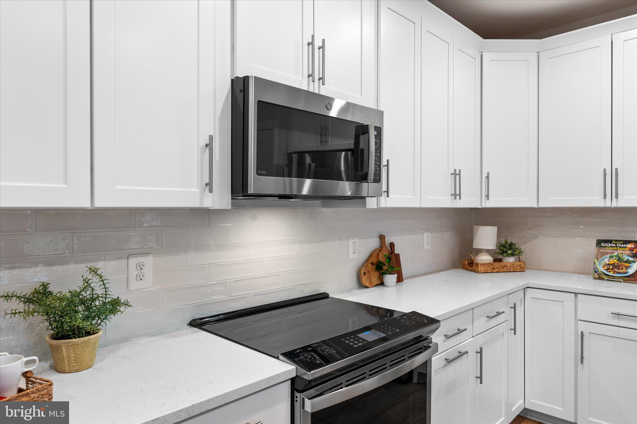 1669 Bandit Loop, Unit 206A Reston, VA 20190 - Photo 55 of 60 a kitchen with stainless steel appliances a white cabinets stove top oven and sink