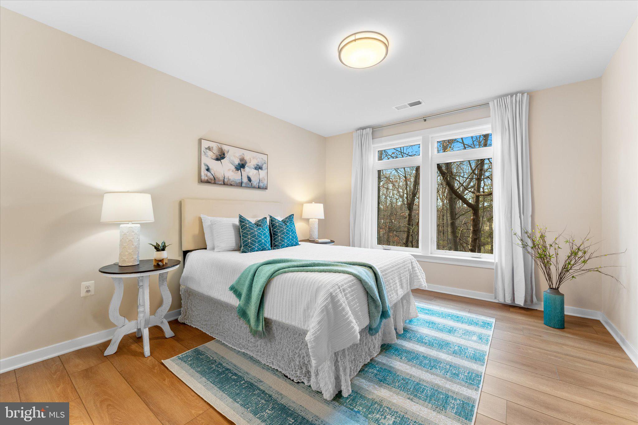 1669 Bandit Loop, Unit 206A Reston, VA 20190 - Photo 7 of 60 a bedroom with a large bed and a window