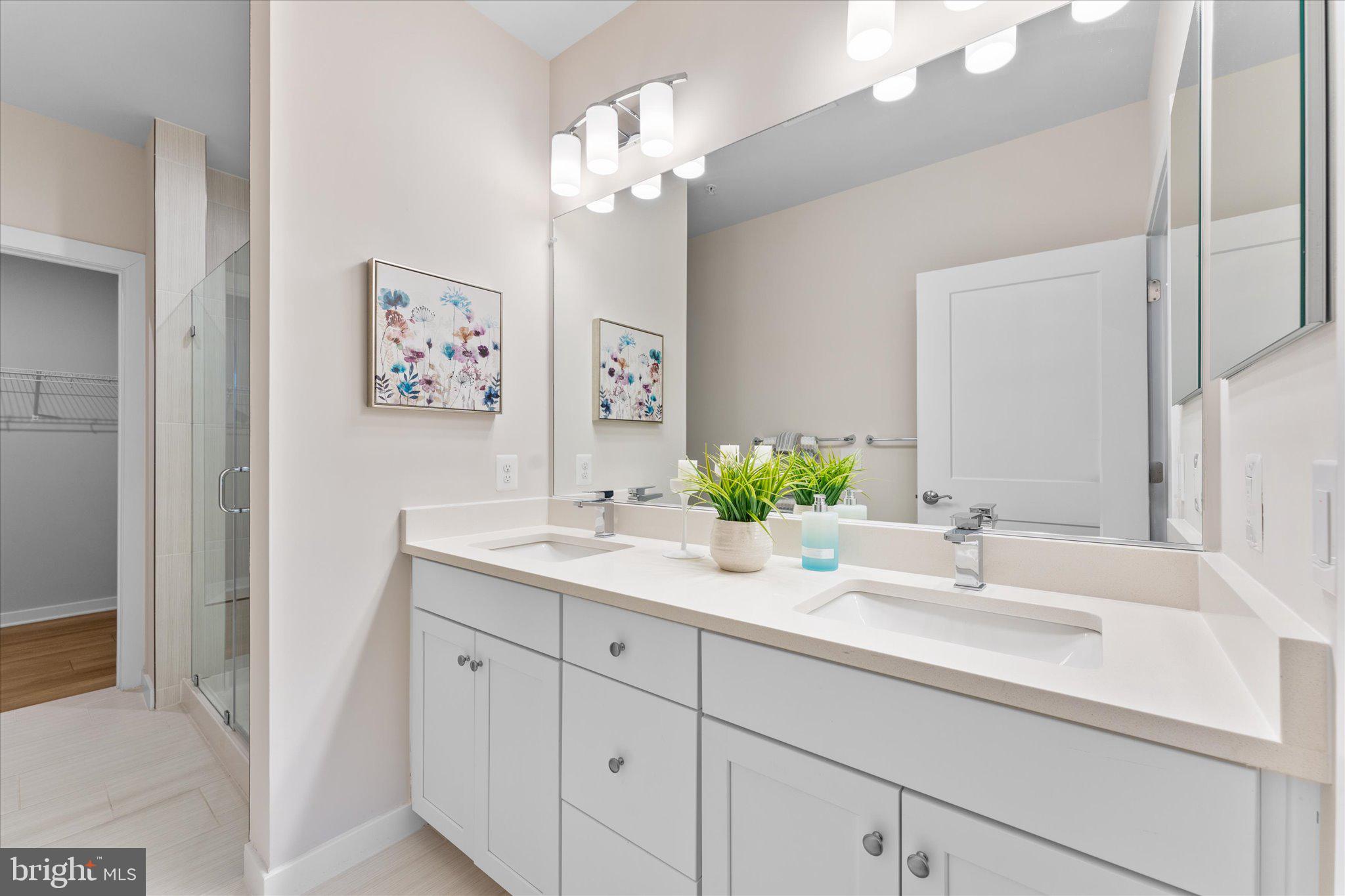 1669 Bandit Loop, Unit 206A Reston, VA 20190 - Photo 8 of 60 a bathroom with a sink double vanity and a mirror