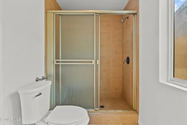 a bathroom with a shower and a toilet