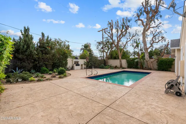 a view of a swimming pool with a yard