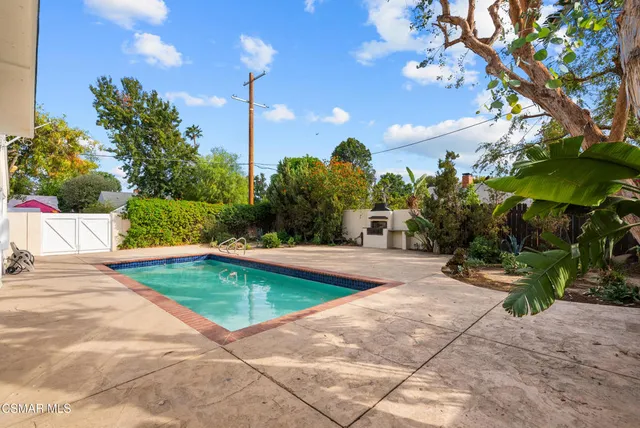 a view of a swimming pool with an outdoor space and seating area