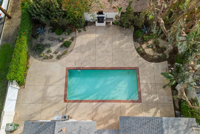 an empty room with a fireplace and potted plants