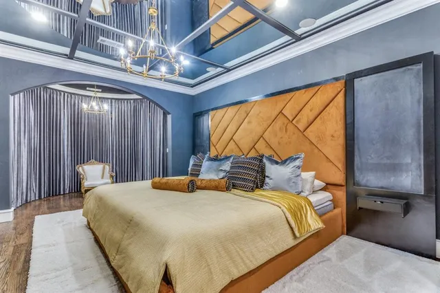 a bedroom with a bed and a chandelier