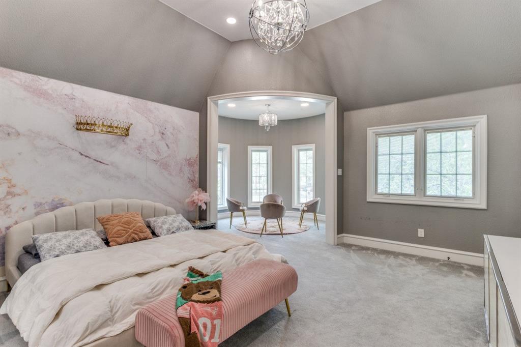 7212 John McCain Road Colleyville, TX 76034 - Photo 23 of 36 a bedroom with a large bed and a chandelier
