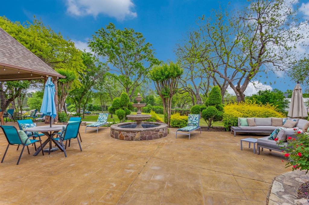7212 John McCain Road Colleyville, TX 76034 - Photo 27 of 36 a view of a backyard with table and chairs potted plants and tree