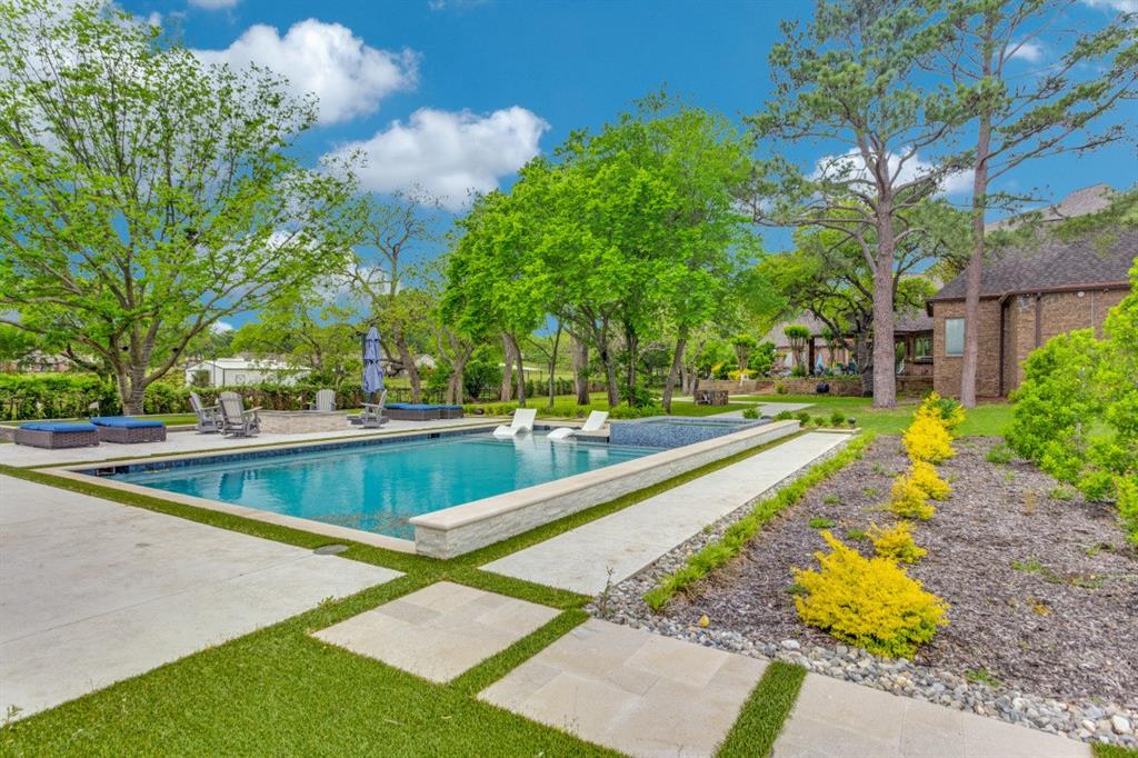7212 John McCain Road Colleyville, TX 76034 - Photo 29 of 36 a view of swimming pool with trees in the background