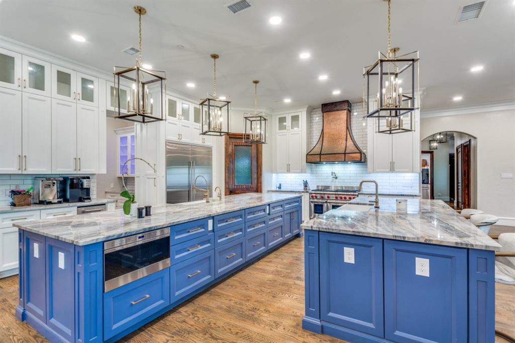 7212 John McCain Road Colleyville, TX 76034 - Photo 7 of 36 a kitchen with kitchen island granite countertop a large counter top space appliances and cabinets