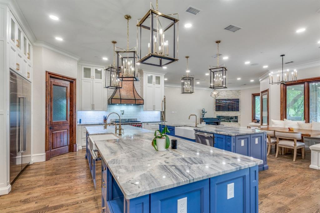 7212 John McCain Road Colleyville, TX 76034 - Photo 8 of 36 a kitchen with stainless steel appliances kitchen island granite countertop a table chairs and a refrigerator