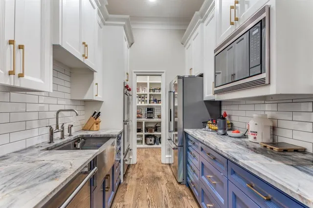 a kitchen with stainless steel appliances granite countertop a stove and a sink