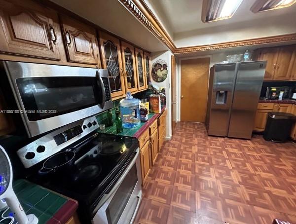 11799 Bailes Road Miami, FL 33170 - Photo 7 of 10 a kitchen with stainless steel appliances a stove a microwave and a refrigerator