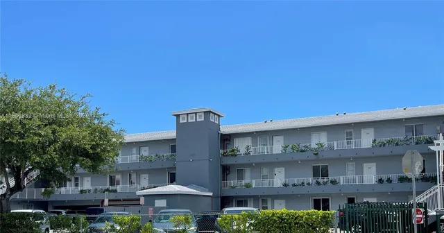 a front view of a building with table and chairs
