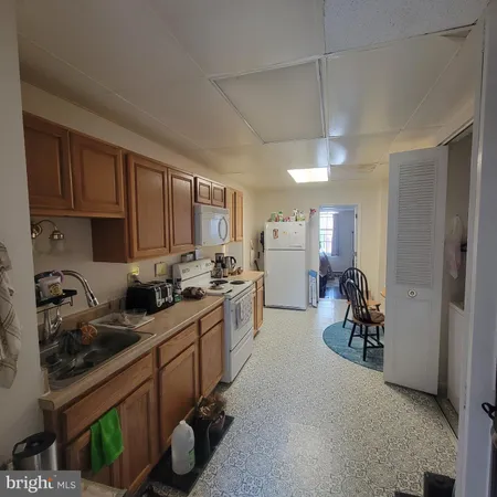 a kitchen with sink cabinets and stove top oven