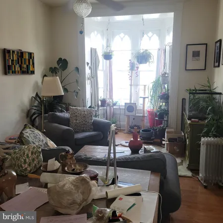 a living room with furniture and a floor to ceiling window