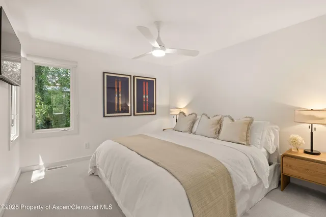 a bedroom with a large bed and a lamp