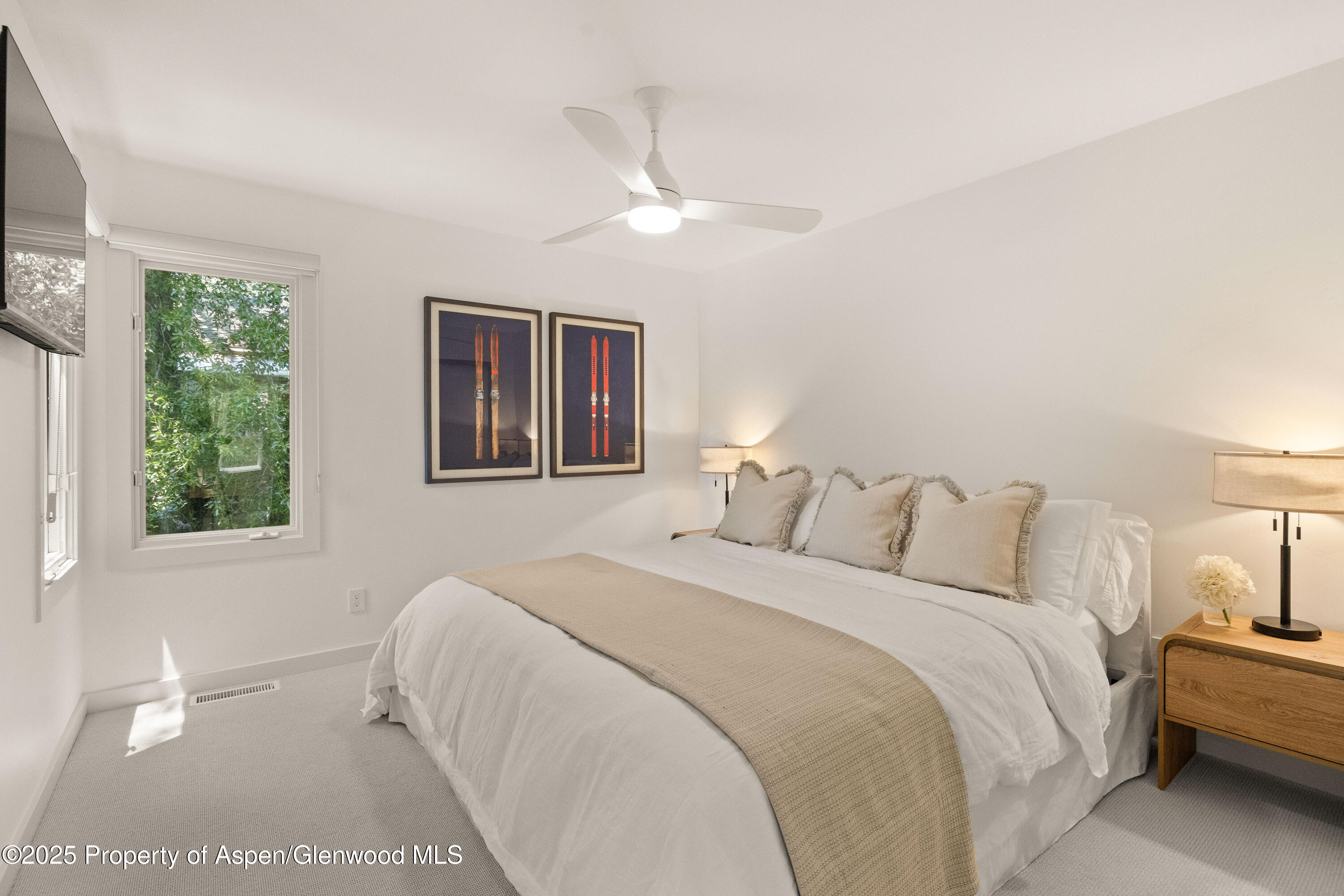 814 West Bleeker Street, Unit B2 Aspen, CO 81611 - Photo 11 of 17 a bedroom with a large bed and a lamp