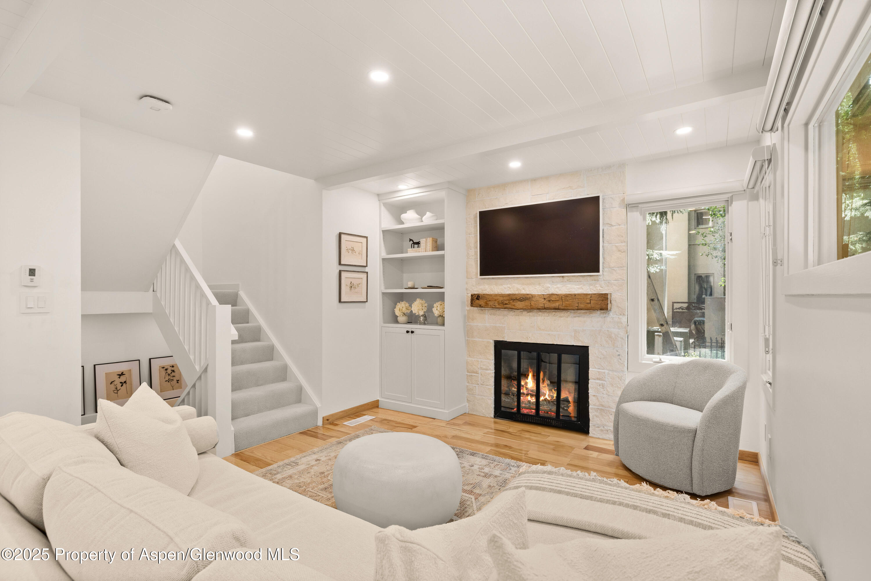 814 West Bleeker Street, Unit B2 Aspen, CO 81611 - Photo 2 of 17 a bedroom with a bed and a fireplace