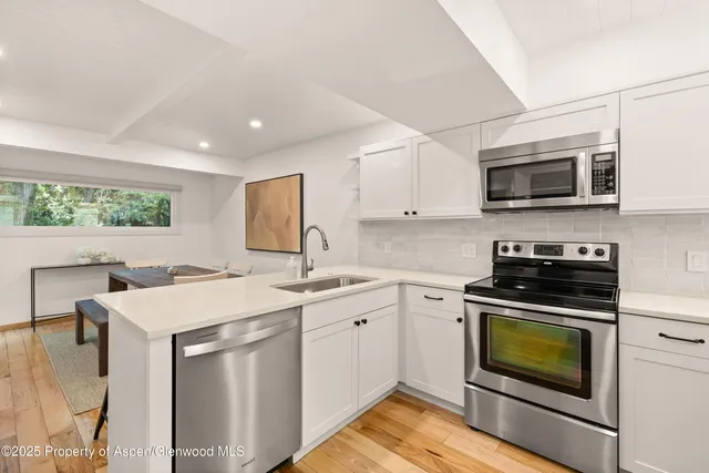 a kitchen with a stove sink and microwave