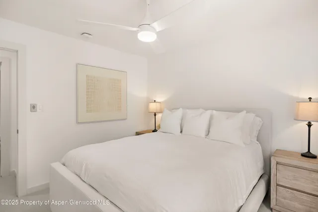 a bedroom with a bed and a night stand