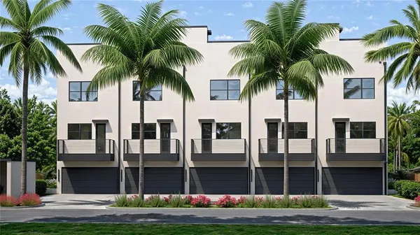a front view of multi story residential apartment building with a yard and entryway