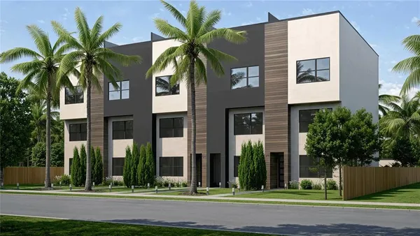 a front view of multiple houses with yard