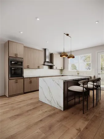 a kitchen with kitchen island granite countertop a stove top oven a sink dishwasher a dining table and chairs with wooden floor