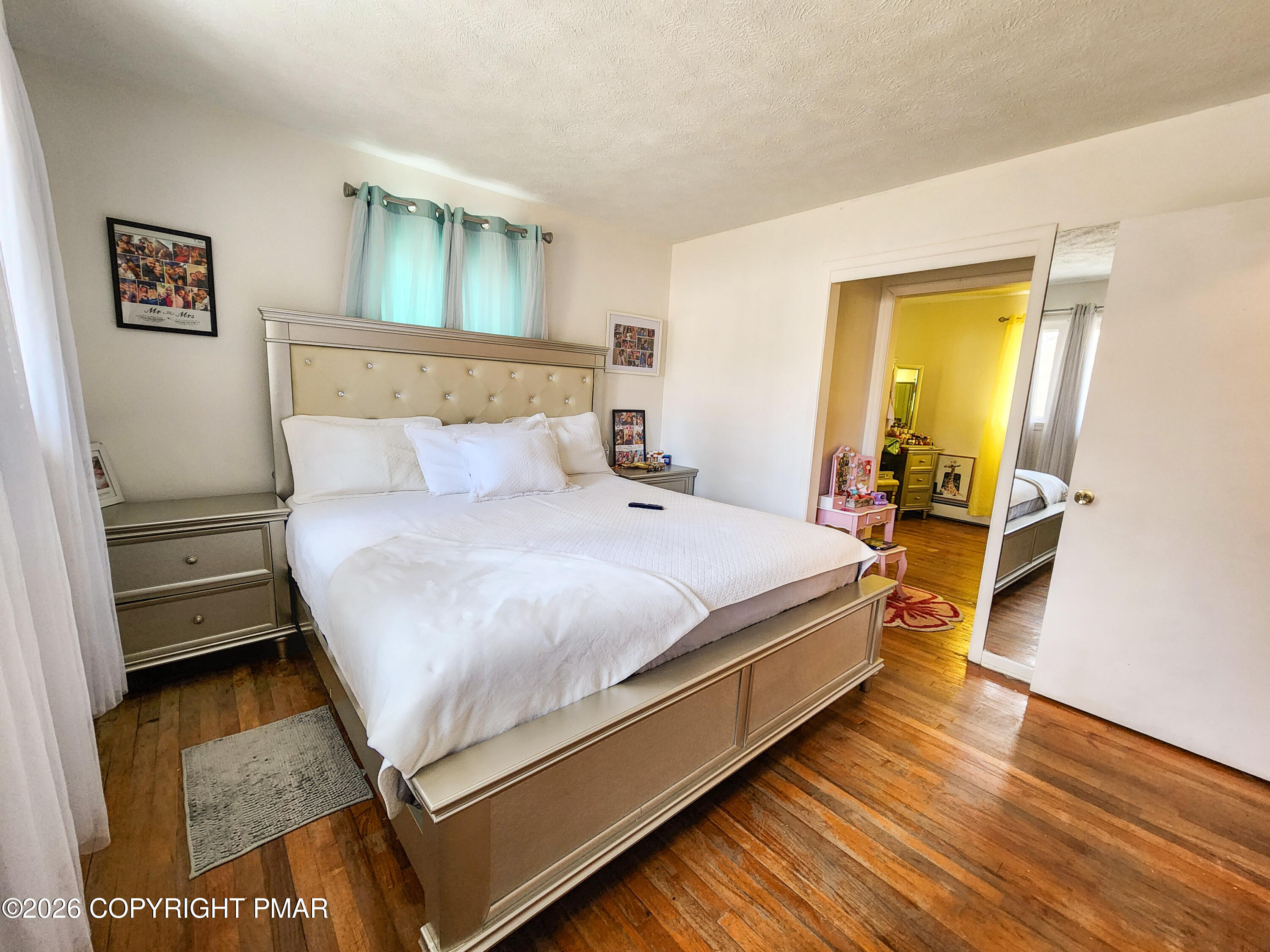 6319 Laurel Road Pocono Summit, PA 18346 - Photo 13 of 22 a bedroom with a bed and wooden floor