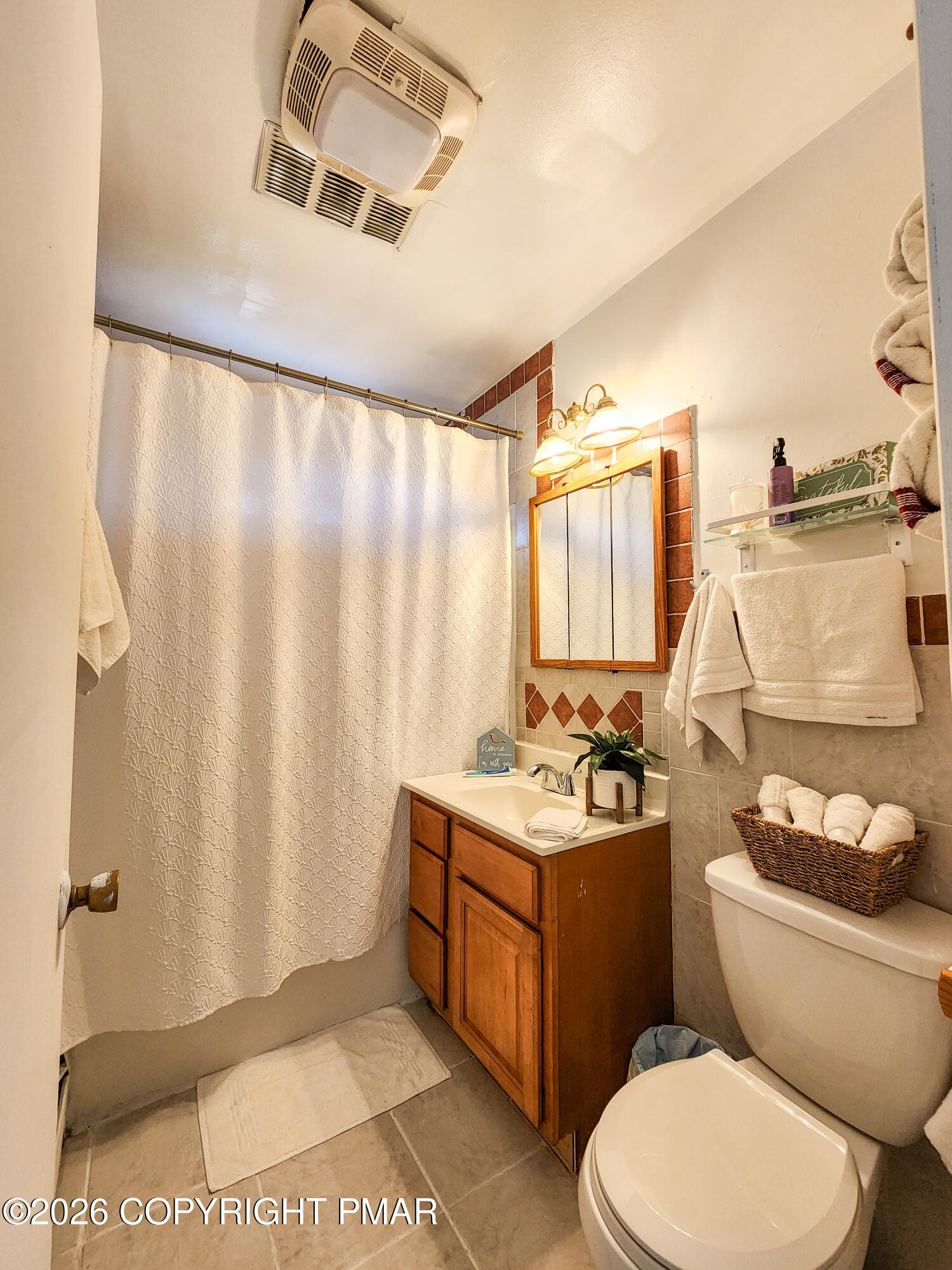 6319 Laurel Road Pocono Summit, PA 18346 - Photo 15 of 22 a bathroom with a toilet sink and mirror