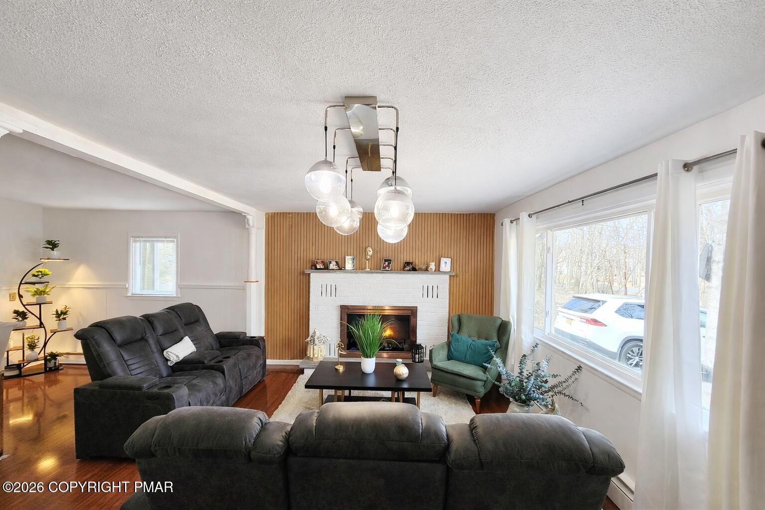 6319 Laurel Road Pocono Summit, PA 18346 - Photo 7 of 22 a living room with furniture and a fireplace