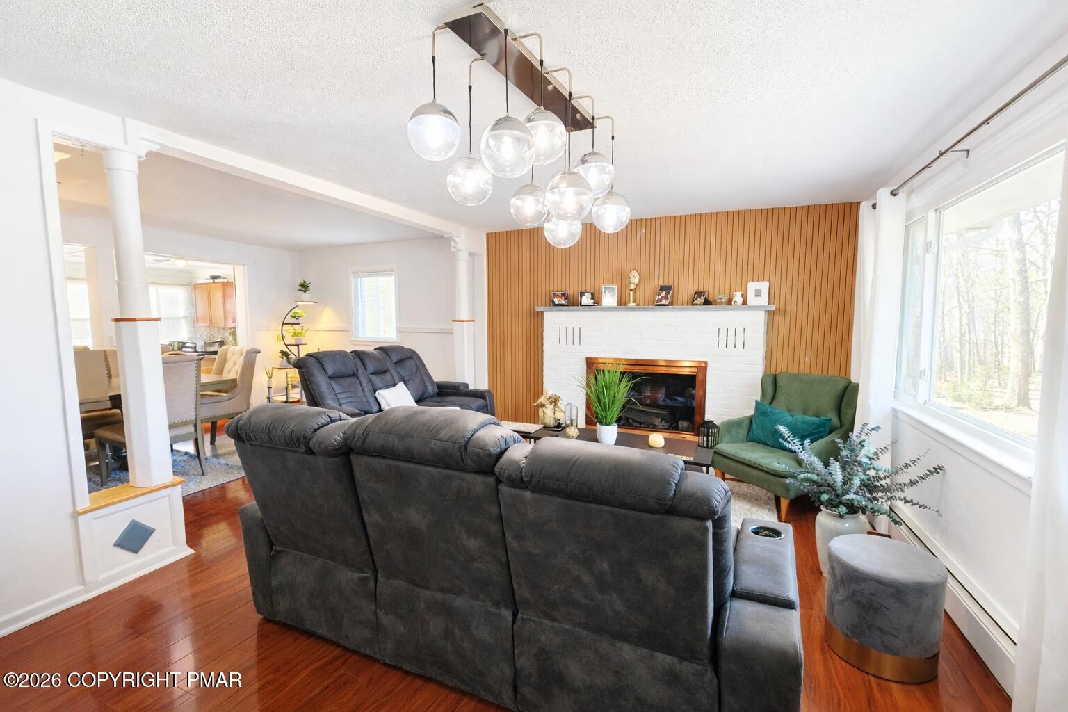 6319 Laurel Road Pocono Summit, PA 18346 - Photo 8 of 22 a living room with furniture a fireplace and a large mirror