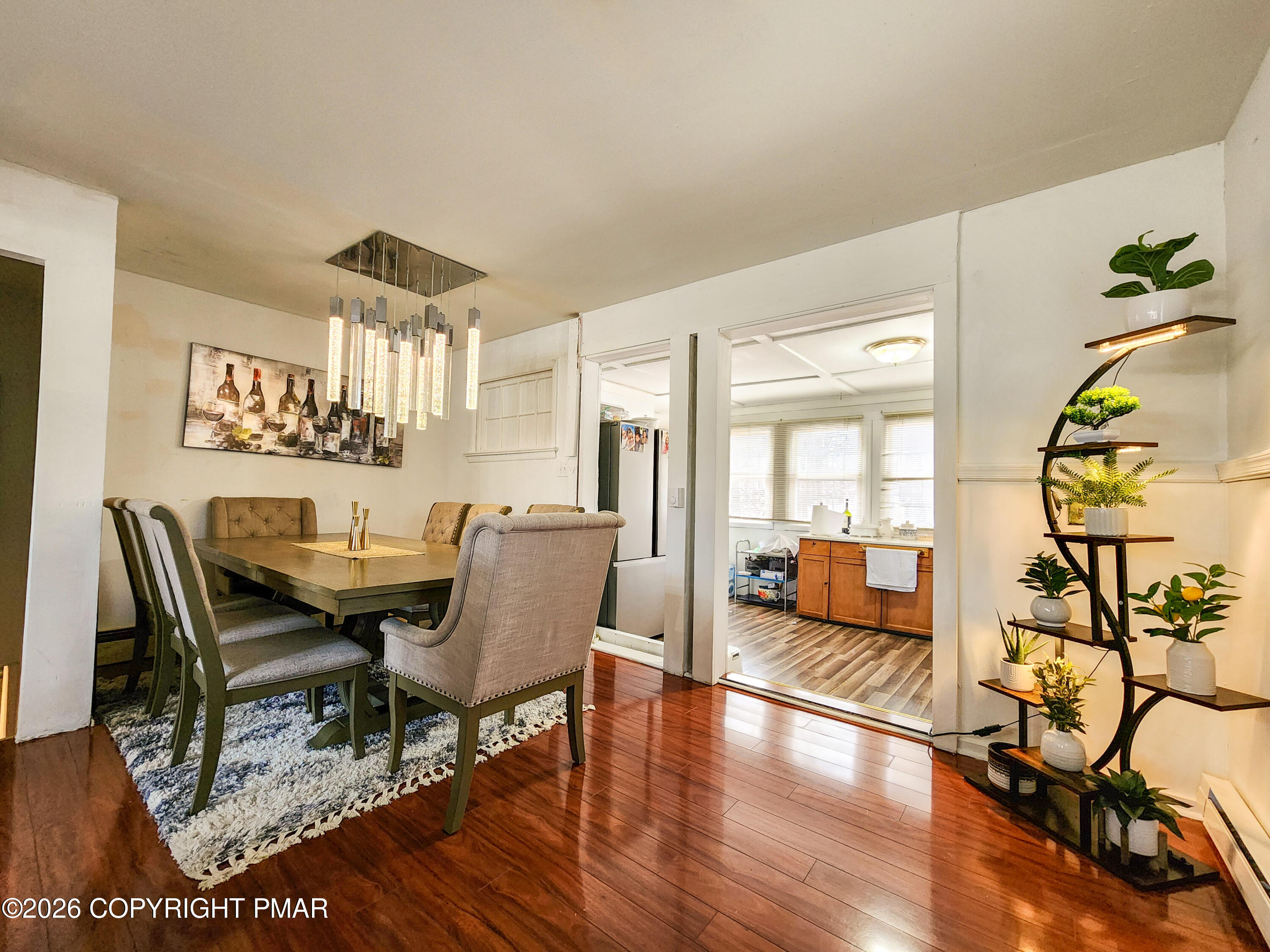 6319 Laurel Road Pocono Summit, PA 18346 - Photo 10 of 22 a view of a dining room with furniture wooden floor and a chandelier