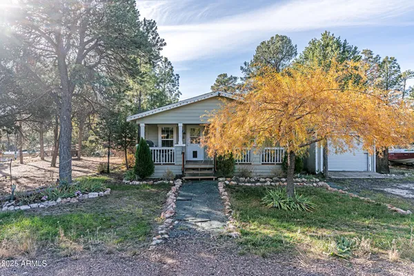 a view of a house with backyard and a tree