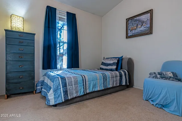 a bedroom with a bed and a dresser