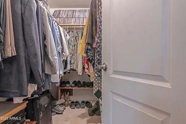 a view of walk in closet with clothes